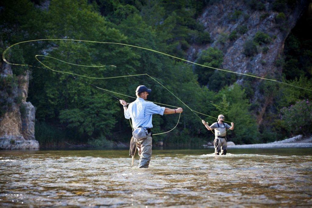 Fisherman fly fishing